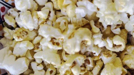 handheld-pickup-shot-over-popcorn-in-a-bowl