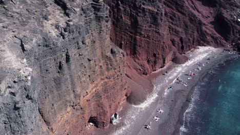 Orbit-drone-shot-to-reveal-famous-Red-Beach-on-Santorini-island