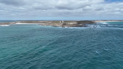 Drone-shot-flying-towards-Corny-Point-lighthouse-near-the-rocky-shores-of-Corny-Point-and-Horse-Shoe-Bay