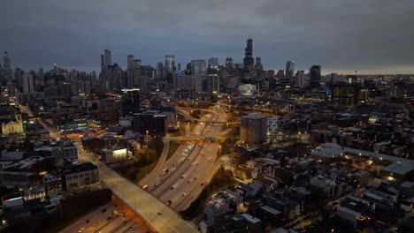 Aerial-view-overlooking-traffic-in-and-out-from-the-downtown,-moody-evening-in-River-West,-Chicago,-USA