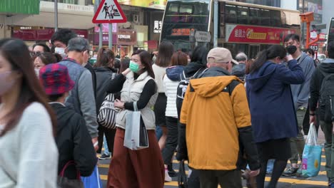Pedestrians-walk-through-a-busy-zebra-crossing-junction-in-Hong-Kong