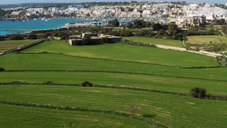 Verdant-Landscape-Though-Mediterranean-Fishing-Village-Of-Marsaxlokk-In-South-Eastern-Region-of-Malta