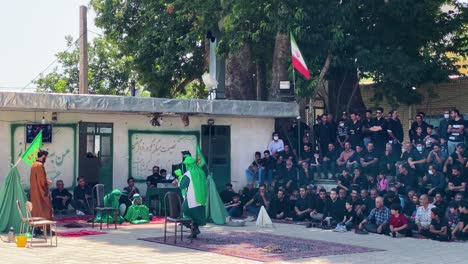Artist-play-the-religion-performance-of-Tazieh-wear-red-green-costume-armor-shield-in-a-ritual-Shia-Muslim-festival-in-rural-area-in-middle-east-in-Iran-Qazvin-to-show-art-of-respect-condolence-grief