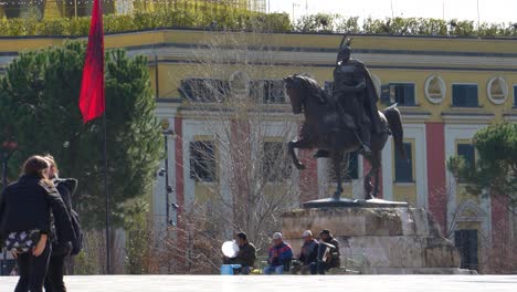 Tirana-city-center-with-people-walking-on-main-square-close-to-Skanderbeg-monument