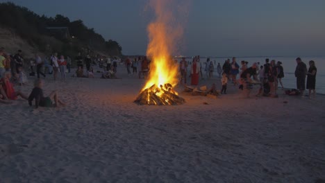 Menschenmassen-Beobachten-Bei-Sonnenuntergang-Brennende-Lagerfeuer-An-Einem-Lettischen-Strand
