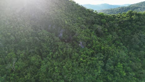 Aerial-Ascent-of-Rainforested-Hill,-Bato-Lighthouse,-Cataduanes,-Philippines