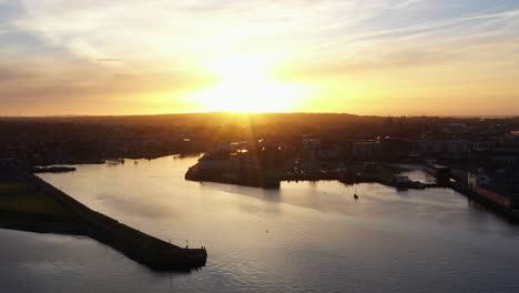 Stunning-sunrise-light-rays-illuminate-Galway-city-featuring-Claddagh-and-Nimmo's-pier