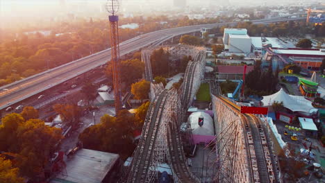 Mexico-City---June-2022:-Sunset-top-view-of-business-downtown-district-of-Mexico-city-in-background-and-La-Feria-amusement-park