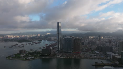Aerial-drone-panning-shot-of-the-ICC-tower-and-high-rise-buildings-in-West-Kowloon-in-Hong-Kong-on-a-clear-day