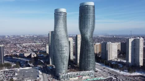 Aerial-shot-of-spiral-apartment-buildings-on-a-sunny-winter-day-in-Mississauga