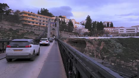 Sidi-M'Cid-Bridge-during-rush-hour:-This-clip-captures-the-energy-and-excitement-of-walking-across-the-bridge-during-rush-hour,-with-bustling-crowds-and-the-sounds-of-the-city-filling-the-air