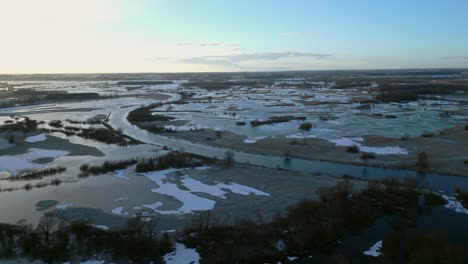 Aerial-view-of-the-flooded-and-frozen-landscape-around-the-Narew-River-in-the-Podlasie-region,-Poland