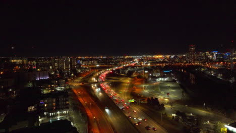 Aerial-view-of-Cars-Driving-Down-the-Interstate-at-Night-in-Denver,-Colorado