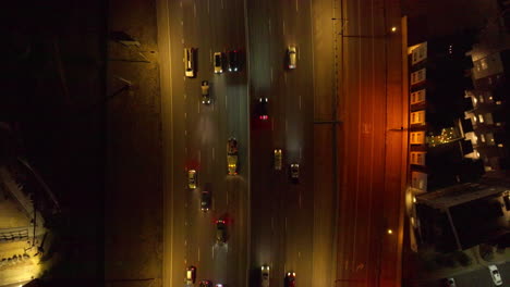 Aerial-view-of-Top-Down-Shot-of-Cars-Driving-Down-Interstate-at-Night-in-Denver,-Colorado