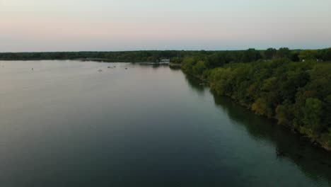 Beautilful-drone-aerial-fly-over-the-green-shores-of-Seneca-Lake-New-York-at-sunset-or-magic-hour