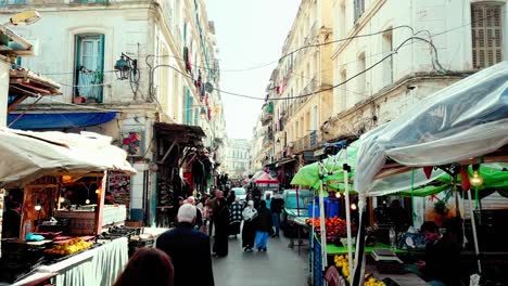 Scenes-of-daily-life-in-Algiers,-including-people-going-about-their-daily-routines,-shopping-in-the-markets,-and-gathering-in-public-spaces
