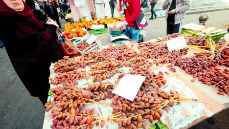Footage-of-the-busy-markets-of-Algiers,-showcasing-the-vibrant-energy-of-the-city-and-the-colorful-stalls-of-vendors-selling-spices,-textiles,-and-other-goods