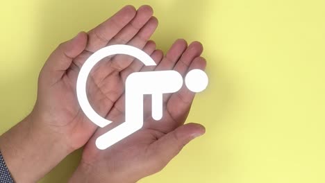Symbol-for-the-'provision-for-the-disabled-or-handicapped-persons'-animation-appearing-on-2-hands-that-are-opened-in-the-shape-of-a-book