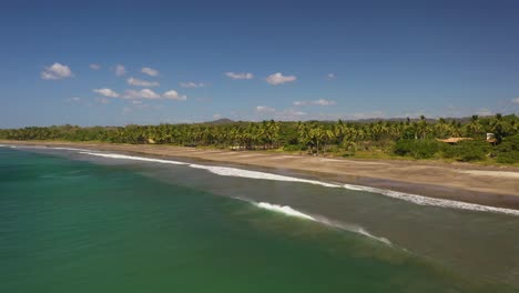 Aerial-footage-of-tropical-water-and-palm-trees-in-stunning-beach-location