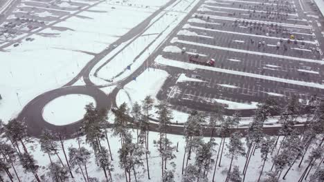 Aerial-Video-of-Snowy-Parking-Lot-in-Riga,-Latvia
