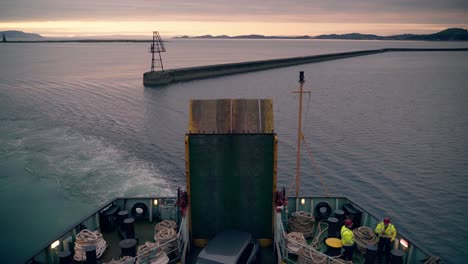 Car-ferry-workers-talking-at-the-rear-of-the-boat-as-the-ship-departs-the-port