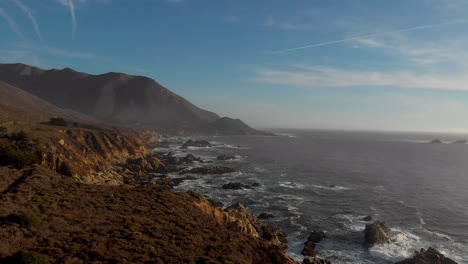 Soar-over-rocky-coastline-during-golden-hour,-northern-california-Big-Sur