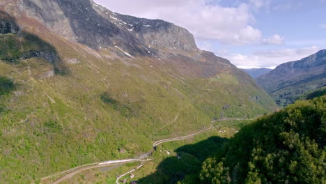 Serpentine-road-and-train-route-through-high-mountains-in-flam,-Norway