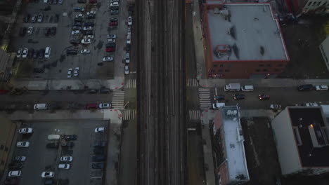 Aerial-view-tilting-over-the-Harlem–125th-street-station,-towards-the-Park-Avenue-Bridge,-in-gloomy-NY,-USA