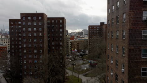 Drone-shot-over-a-train-and-apartments,-revealing-the-cityscape-of-Upper-Manhattan,-NY