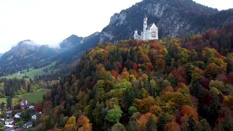 Aerial-View,-Neuschwanstein-Castle,-Germany-in-Colorful-Autumn-Landscape-Scenery,-Establishing-Drone-Shot