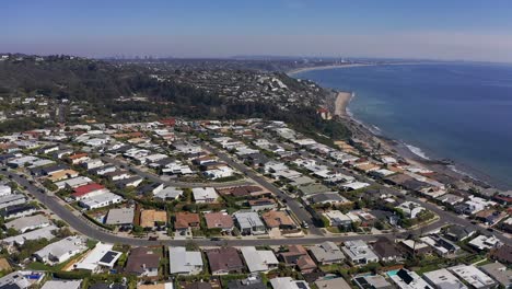 Descending-and-panning-aerial-shot-over-a-housing-community-on-Malibu-Bluffs-along-the-coast-of-California