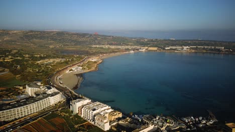 Drone-Volando-Hacia-La-Playa-De-Mellieha-En-Una-Hermosa-Mañana-En-Malta