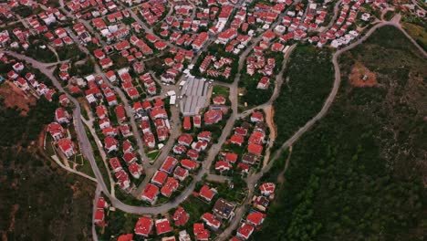 Datça-town-scenery-from-above,-small-city-of-Aegean-Turkey-under-dramatic-cloudscape-with-rainbow