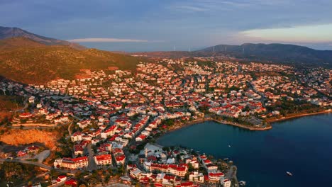 Scenic-aerial-view-of-Turkish-seaside-town-sunlit-by-sunrise,-Datça,-Reşadiye-peninsula