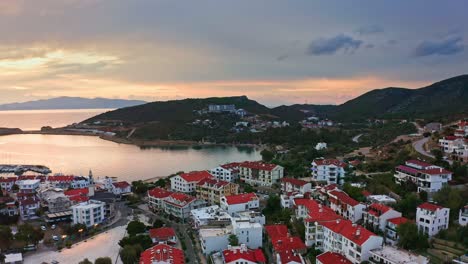 Flying-above-residential-houses-of-small-seaside-town-at-aegean-region-of-Turkey-after-romantic-sunrise