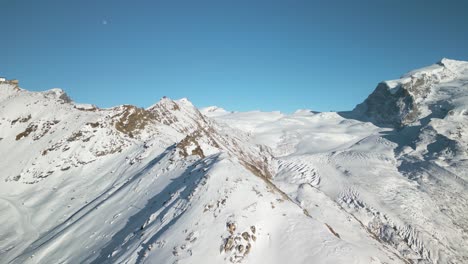 Aerial-View-of-Snowy-Ridgeline-on-Alpine-Peak-in-Switzerland-during-Winter