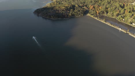 Speed-boat-passing-through-Hudson-River-aerial-4k-during-sunset