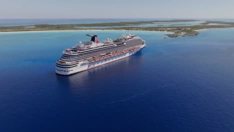 Aerial-view-approaching-the-Carnival-dream-cruiseliner-on-the-coast-of-the-Little-San-Salvador-Island,-Bahamas