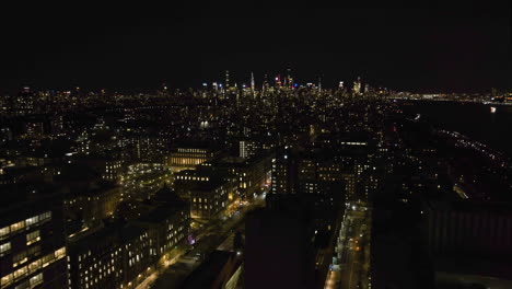 Drone-shot-over-night-lit-streets-in-Morningside-heights,-Manhattan,-New-York,-USA