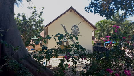 An-upper-class-African-house-with-pink-flowers-on-the-island-of-Bubaque,-Guinea-Bissau