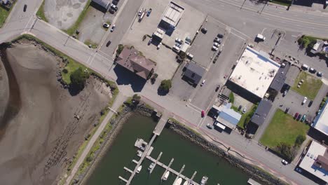 Dramatic-4k-descending-aerial-birdseye-view-of-boat-harbor-and-dock-in-Bandon,-Oregon