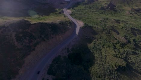 Cars-driving-along-winding-rocky-mountain-pass-drone-4k
