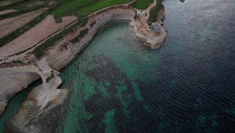Munxar-Window-Top-View,-Limestone-Cliff-Side,-Turquoise-Water,Green-Fields,-Malta-Island