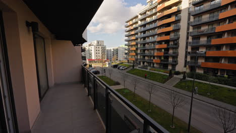 View-from-a-terrace-of-a-luxury-apartment-complex,-residential-designed-buildings-exterior,-on-a-sunny-day