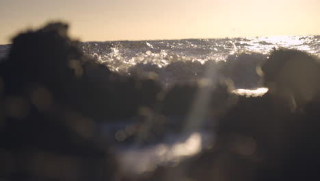Ocean-waves-crashing-on-rocks-with-early-morning-sun