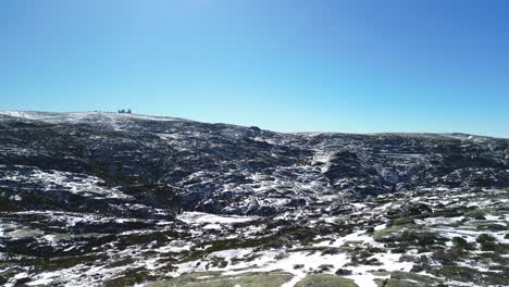 Drone-flyover-Snowy-rugged-landscape-of-Serra-da-Estrela,-Highest-point-in-Portugal