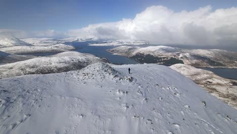 Hiker-reaching-the-summit-of-Beinn-na-Caillich-on-Isle-of-Skye-in-Scotland