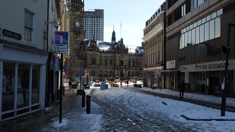 People-walking-in-snowy,-sunny-city-centre-streets,-Sheffield