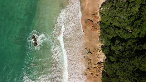 Waves-breaking-on-shoreline-of-Hot-Springs-in-New-Zealand