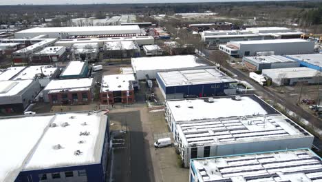 Aerial-of-large-industrial-site-with-snow-covered-rooftops-and-clean-roads